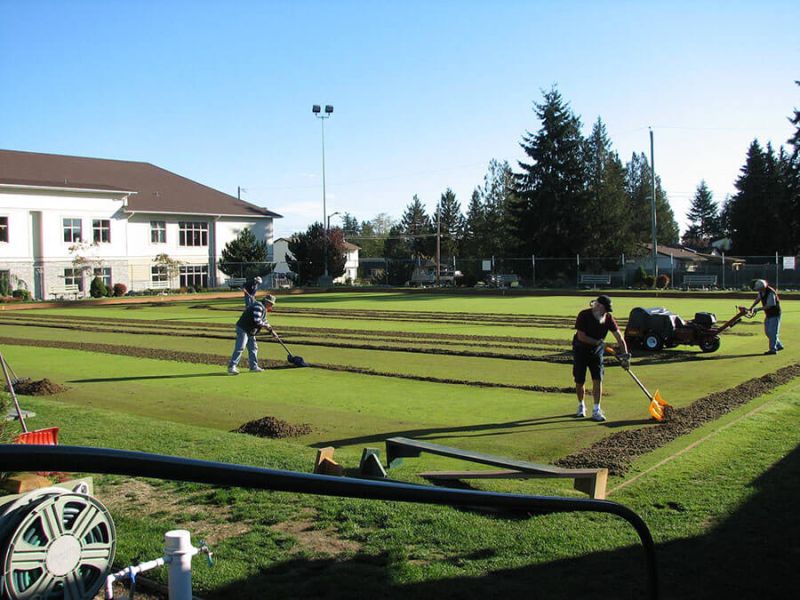 Parksville Lawn Bowling Club members taking care of the green