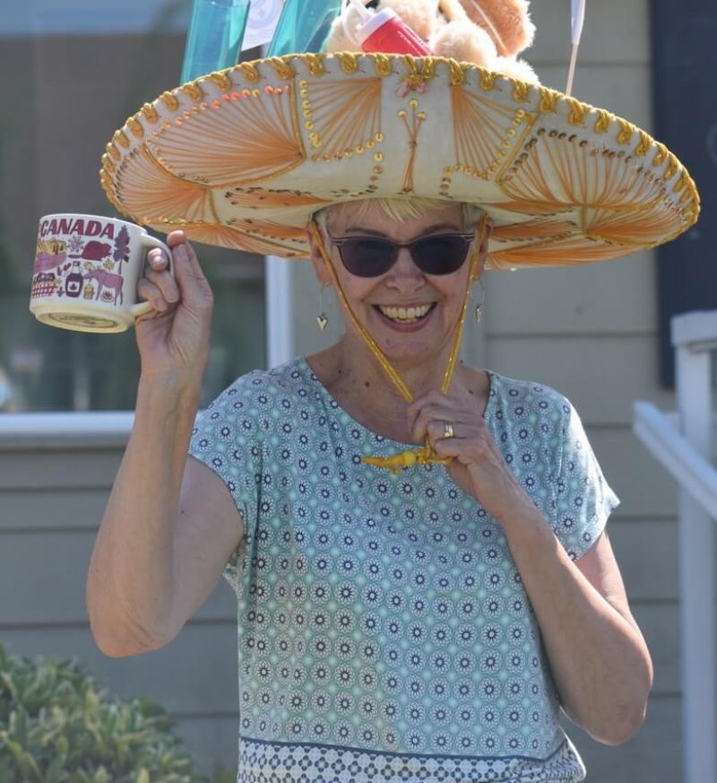 Parksville Lawn Bowling Club member smiling with hat on holding a cup