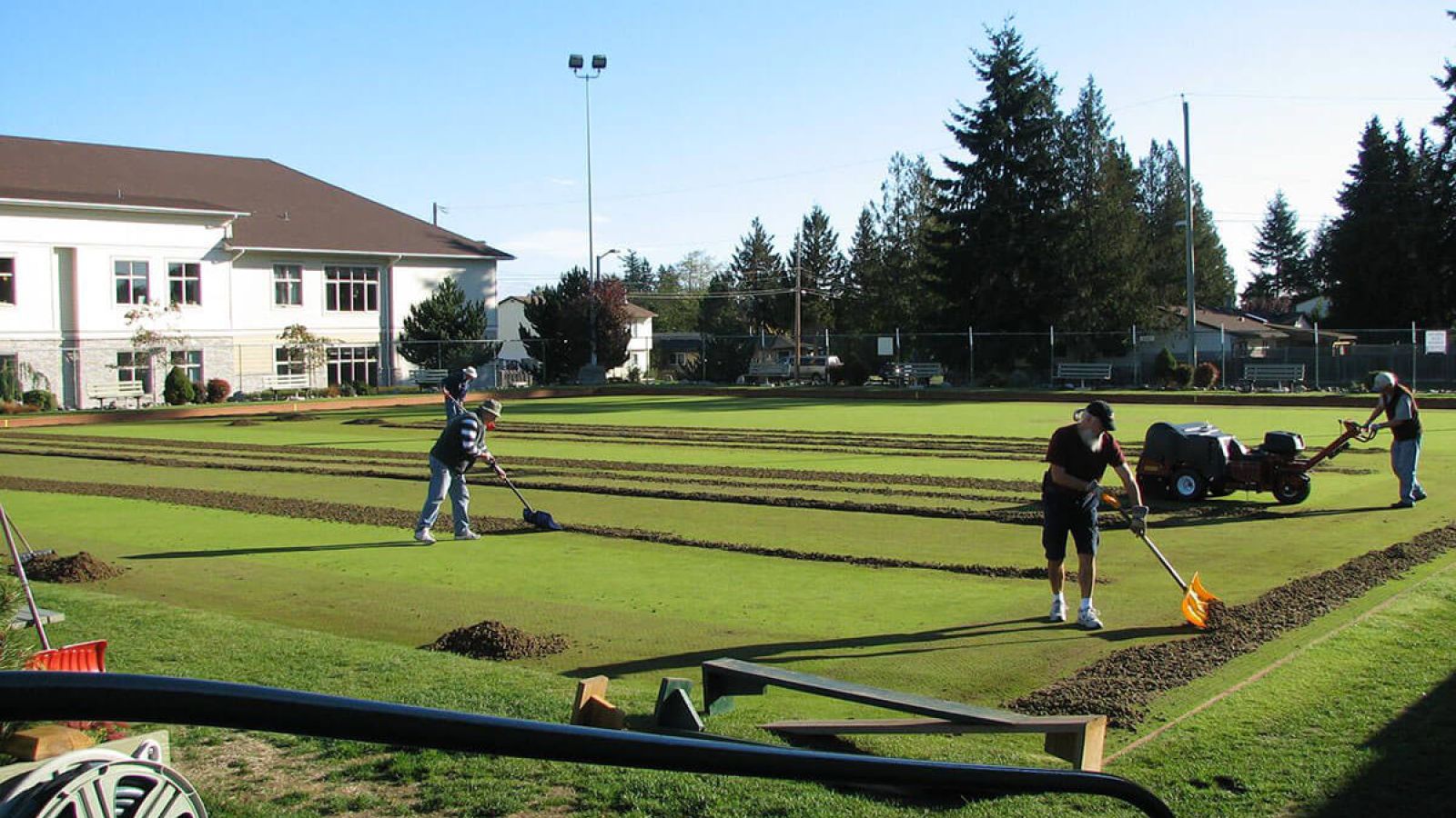 Parksville Lawn Bowling Club members cleaning the greens