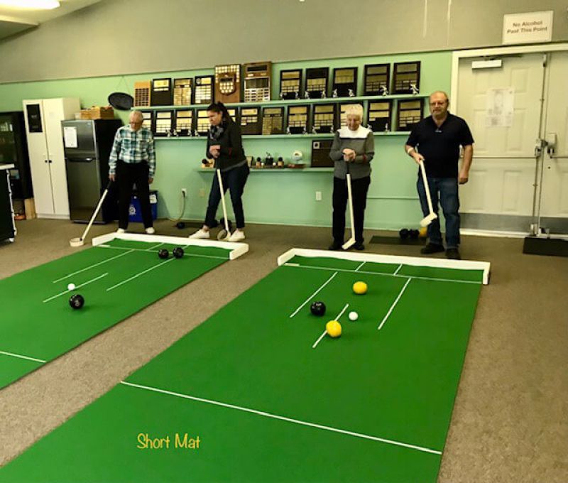 Parksville Lawn Bowling Club members playing lawn bowling inside