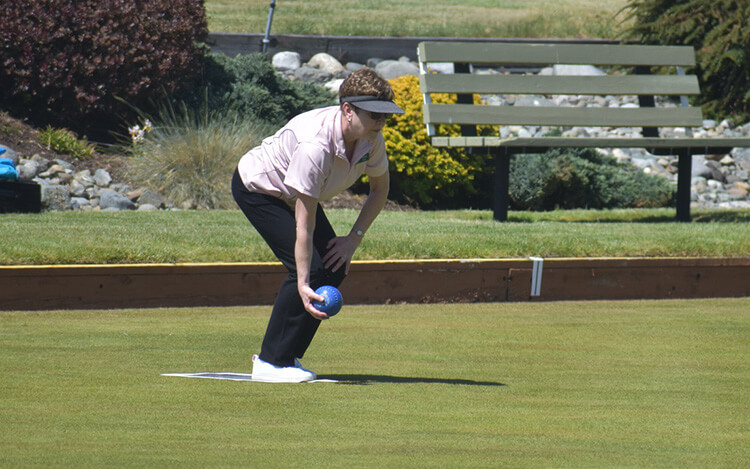 Parksville Lawn Bowling Club member getting ready to bowl