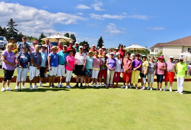 Parksville Lawn Bowling Club members on Victoria Day with sky in the background